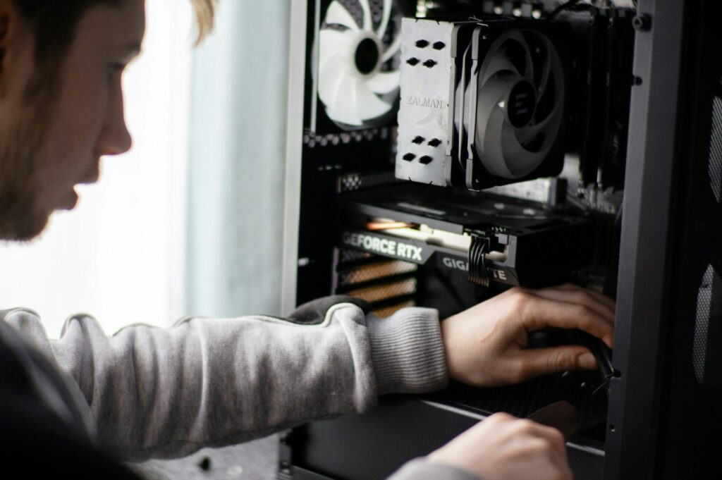 an IT man is repairing a computer